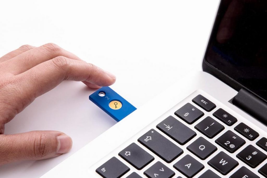 A YubiKey in a computer about to be pressed